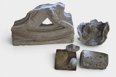three pieces of stone that are sitting on a white surface