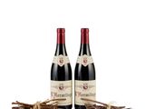 a couple of bottles of wine sitting on top of a table
