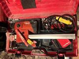 a red tool box with tools in it on the ground