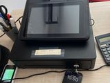 an image of a cash register and a cell phone on a desk