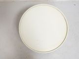 a white toilet bowl sitting on a tiled floor
