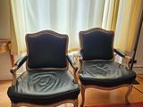 two chairs that are next to each other on a rug