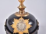 a black and gold bell with a sunflower on it