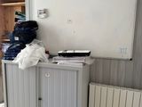 a white board on the wall next to a cabinet
