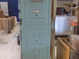 a blue door in the middle of a room filled with furniture
