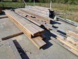 several pieces of wood are stacked on top of each other in a yard