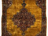 un tapis persan ancien aux couleurs dorées et marron