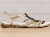 a close up of a pair of sandals on a wooden table