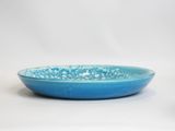 two blue bowls are sitting side by side on a white surface
