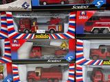 a lot of red and white toy trucks on display