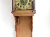 a clock hanging on the wall with a clock face on it