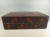 an old wooden box sitting on top of a white table