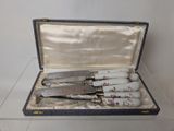 four knives in a case on a table