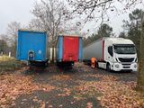 two trucks parked next to each other on the side of the road