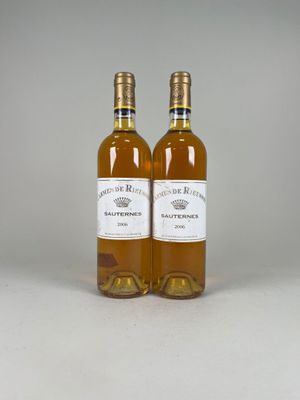 two bottles of wine sitting next to each other on a table