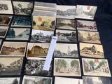 a lot of old postcards that are on a table