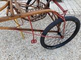 a bike that is sitting on the ground with a basket attached to it