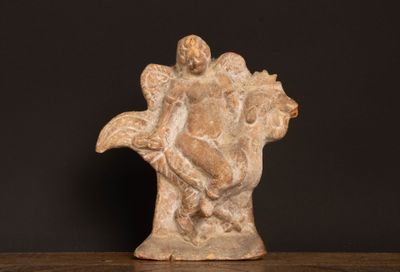 statue of a woman holding a bird on a wooden table
