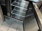 an open refrigerator with a door that is on the floor