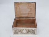 an old silver box with a lid on a white surface