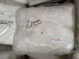 a pile of white pillows that are wrapped in plastic