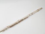 an old flute with a wooden handle sitting on a white surface