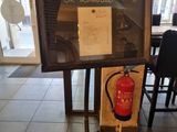 a sign with a fire extinguisher in front of it