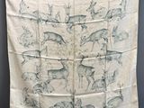 an image of a white and blue scarf with animals on it