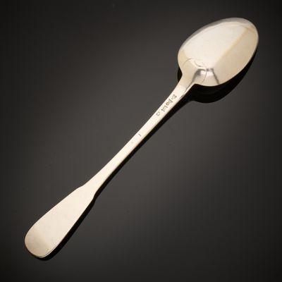 a close up of a spoon on a table with a black background