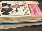 a stack of magazines sitting on a table with a pen
