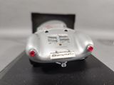 a silver model of a car on a black table