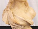 marble bust of a woman wearing a turban on a black table
