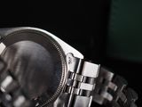 a close up of a watch on a table