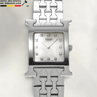 a close up of a watch on a white surface