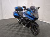 a picture of a blue and black motorcycle parked on a checkered floor