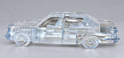 a clear toy car that is sitting on a table