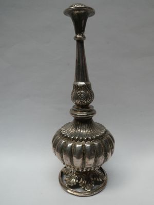 an antique silver plated candle holder on a white background