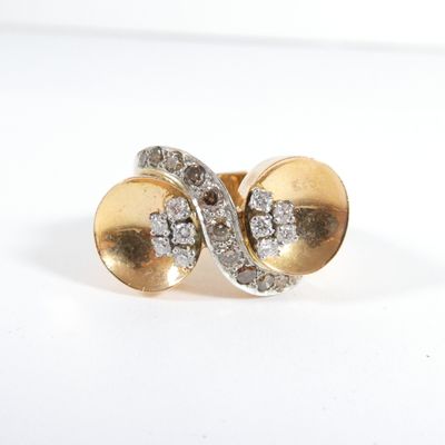 une photo représentant une paire de boucles d'oreilles en or et diamants posées sur une surface blanche