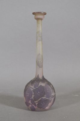 a glass vase with a purple flower design on it