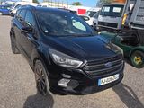 the black ford kuga is parked in the parking lot