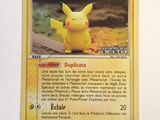 the pokemon card has a picture of a pikachu sitting on top of it