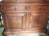 a wooden cabinet with a mirror on top of it
