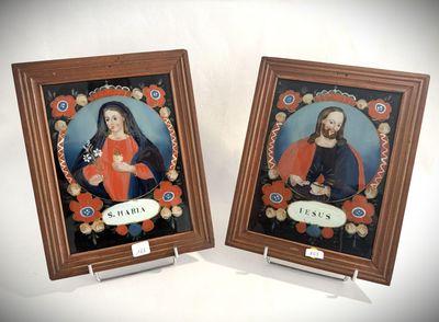 two framed pictures of jesus and mary on a white background