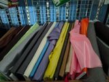 a lot of different colored fabrics on a table