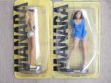 two action figures of a woman in a blue top and a woman in a white skirt