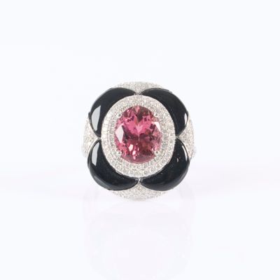 a close up of a ring with a pink and black flower