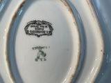 a white and blue plate with a picture of a train on it