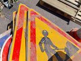 a yellow and red street sign sitting on the side of the road