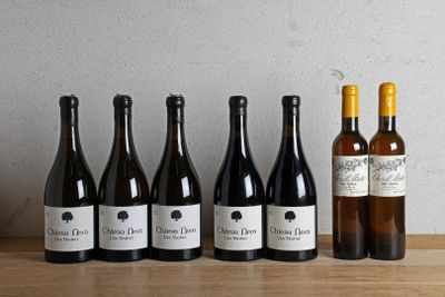 six bottles of wine are lined up on a wooden table