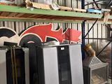 several refrigerators and freezers are stacked on pallets in a warehouse